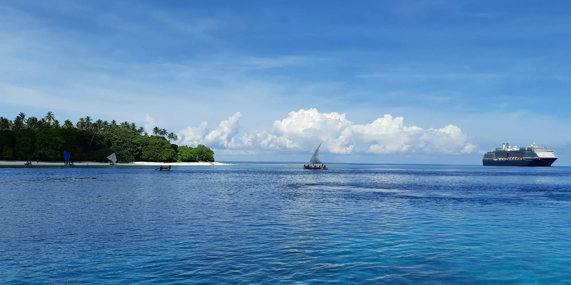 Island from the sea in Papua New Guinea with catamaran and cruise ship