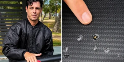 Dave Seymour zeigt die Zahnspuren eines Hais an seinem beschädigten E-Foil-Board